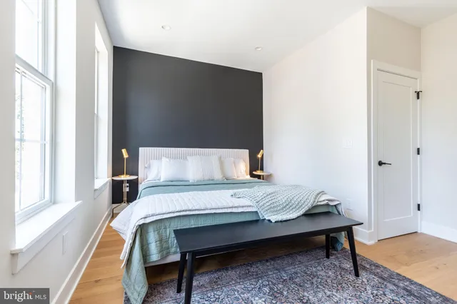 a bedroom with a bed and a window