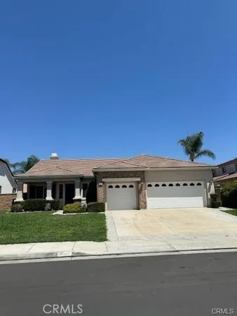 a view of house with yard and car parked