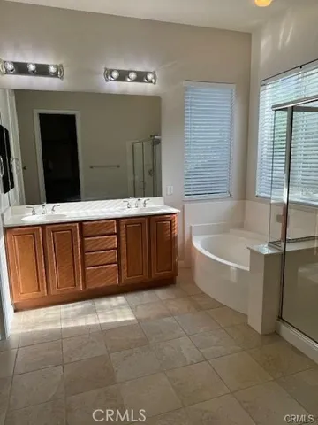 a bathroom with a tub sink and mirror