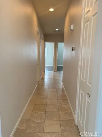 a view of hallway with a window and a mirror