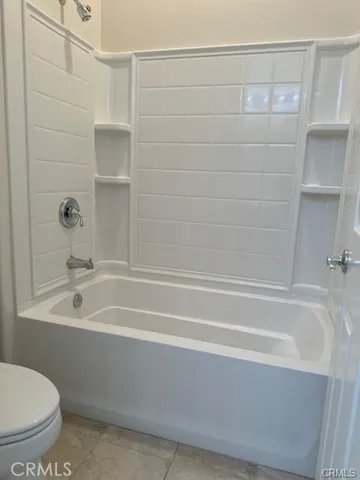 a bathroom with bathtub and shower