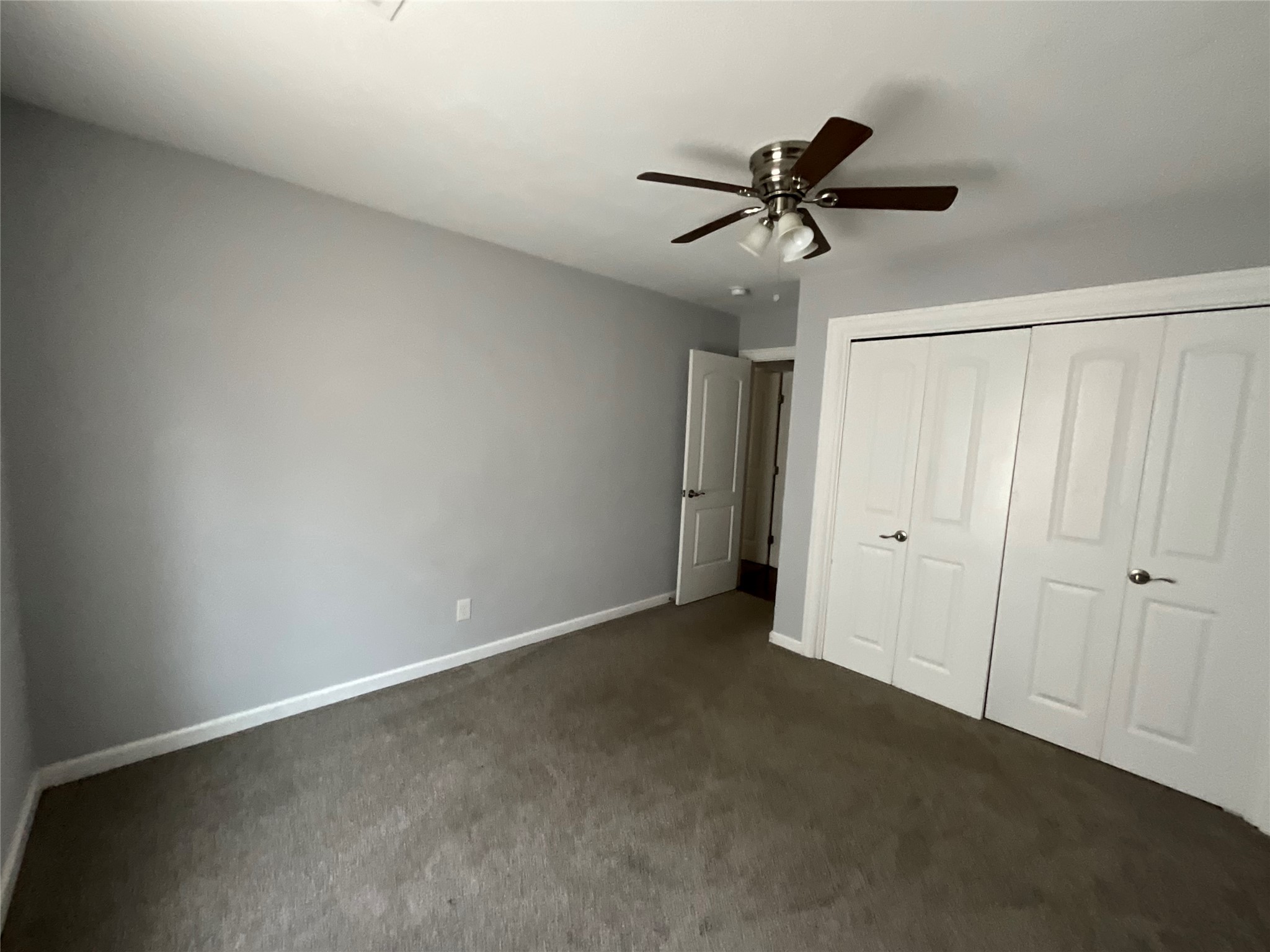 239 Old Firetower Road Bastrop, TX 78602 - Photo 33 of 39 Unfurnished bedroom with a closet, ceiling fan, and dark carpet