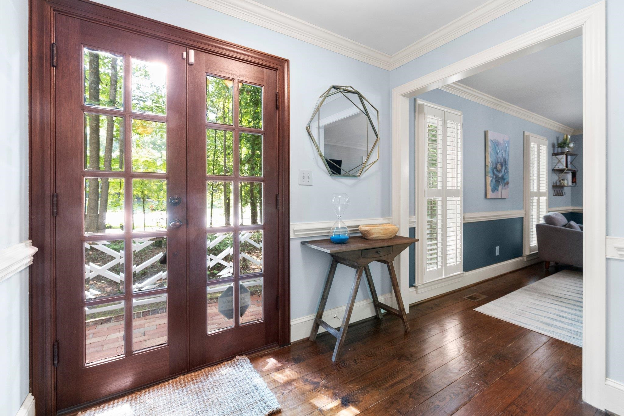 Welcoming entry foyer with unique hardwood floors and crown molding throughout main level. Foyer