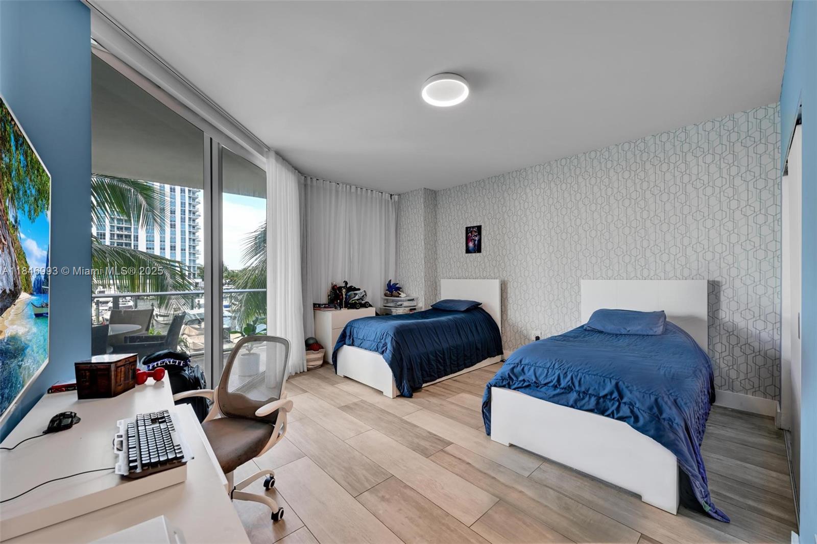 17111 Biscayne Boulevard, Unit 207 North Miami Beach, FL 33160 - Photo 14 of 54 a bedroom with a bed and glass window