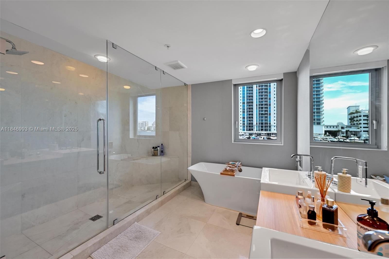 17111 Biscayne Boulevard, Unit 207 North Miami Beach, FL 33160 - Photo 18 of 54 a very nice looking room with a large window and chandelier