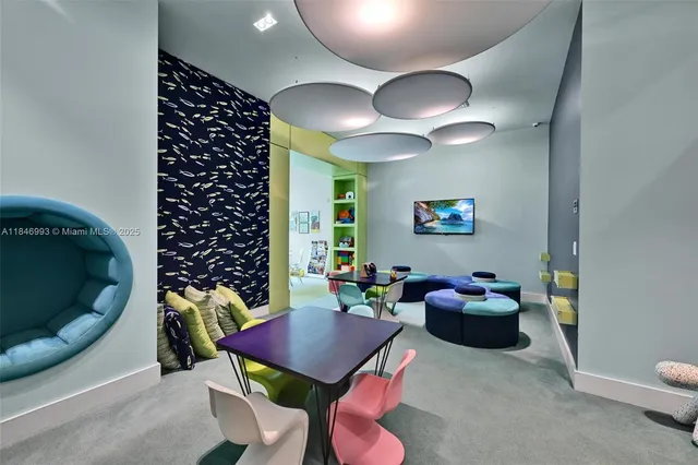 a living room with furniture a chandelier and a rug