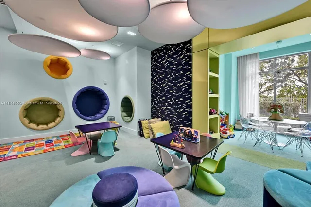 a living room with furniture and a floor to ceiling window