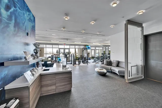 a room with gym equipment and a view of living room