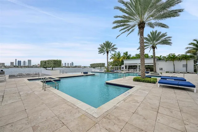 a view of swimming pool with outdoor seating and a tub