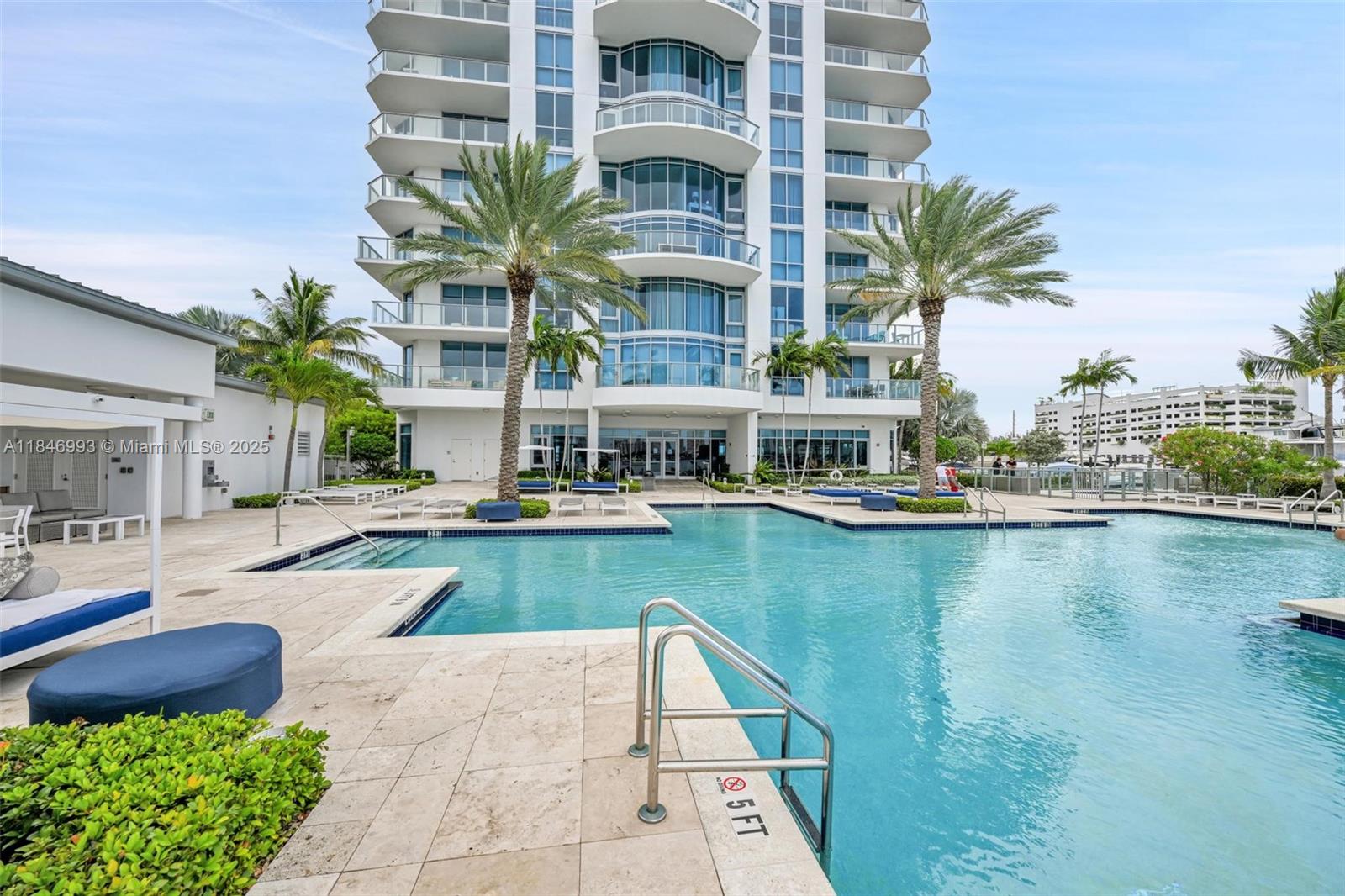 17111 Biscayne Boulevard, Unit 207 North Miami Beach, FL 33160 - Photo 35 of 54 a view of a swimming pool with a lounge chairs
