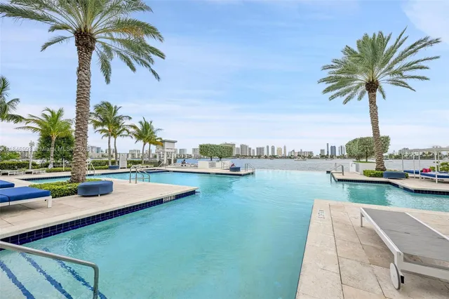 a view of swimming pool with a table and chairs