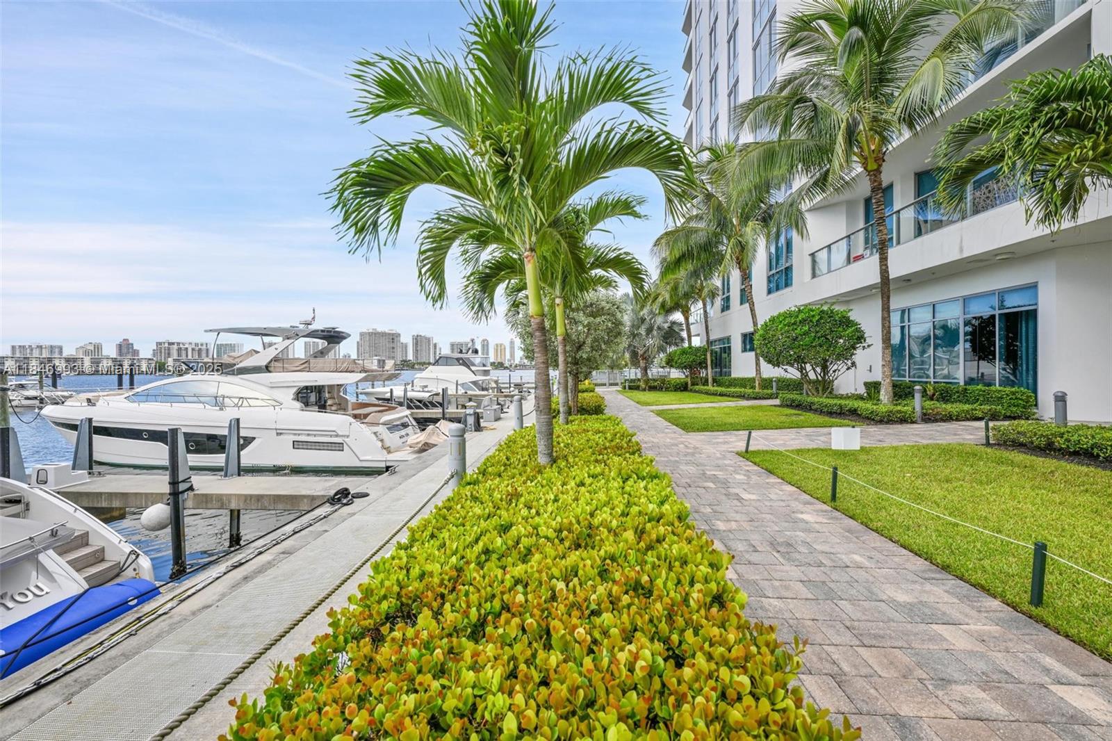 17111 Biscayne Boulevard, Unit 207 North Miami Beach, FL 33160 - Photo 39 of 54 a view of a swimming pool with a garden and plants