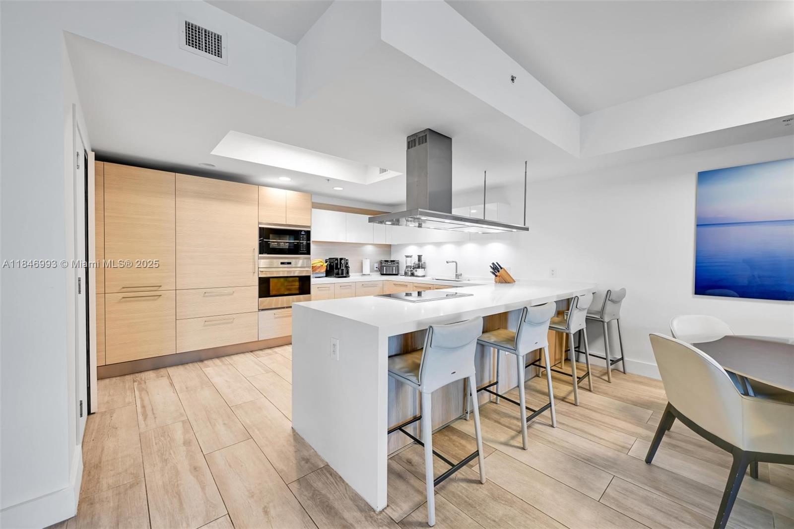 17111 Biscayne Boulevard, Unit 207 North Miami Beach, FL 33160 - Photo 8 of 54 a kitchen with stainless steel appliances kitchen island granite countertop a sink and cabinets