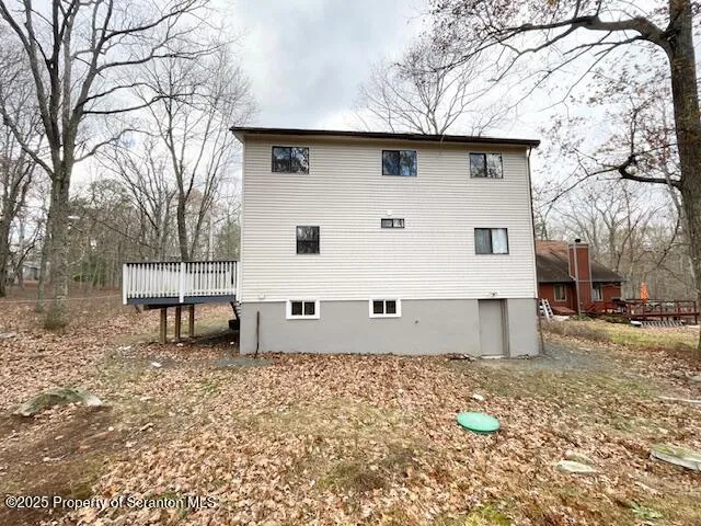 a view of a white house with a yard and sitting area