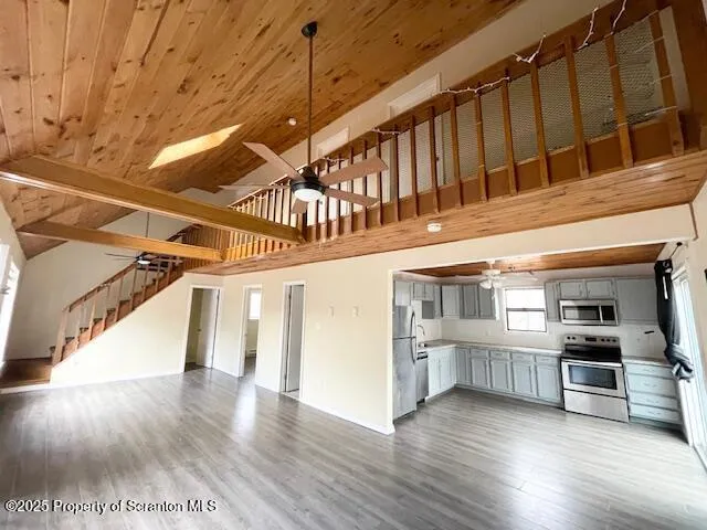a view of entryway and kitchen with wooden floor
