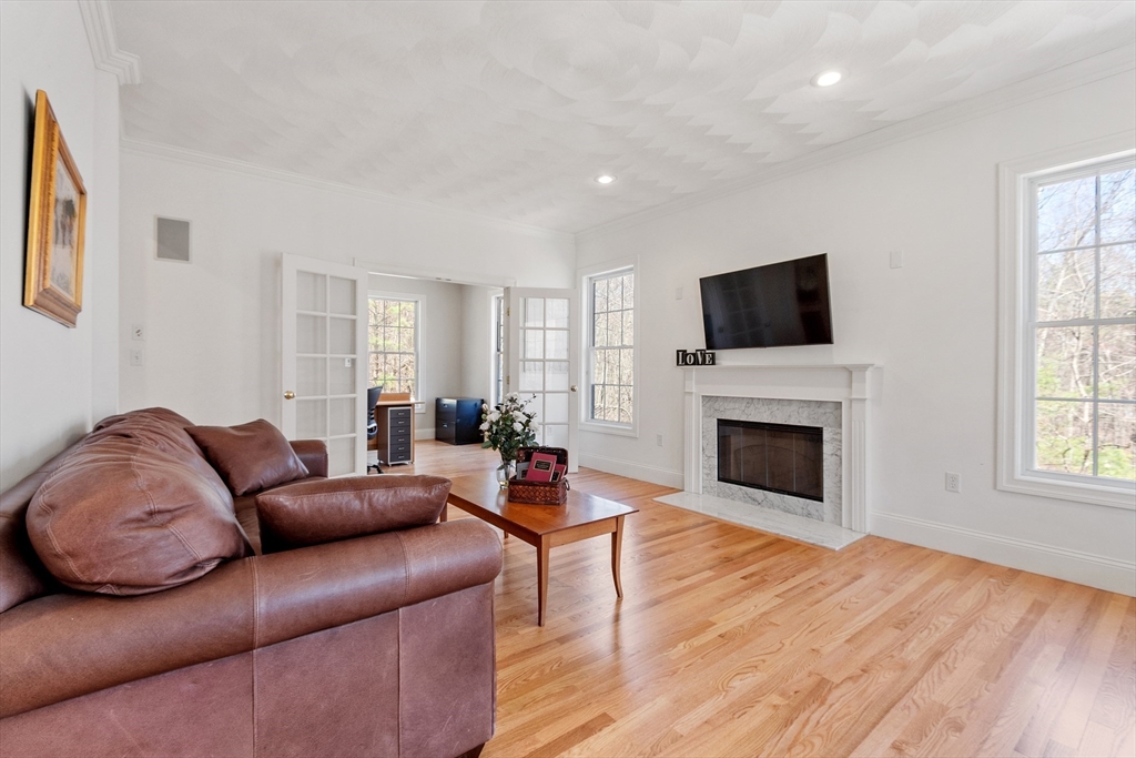 18 Danforth Lane Bolton, MA 01740 - Photo 11 of 29 a living room with furniture a fireplace and a flat screen tv