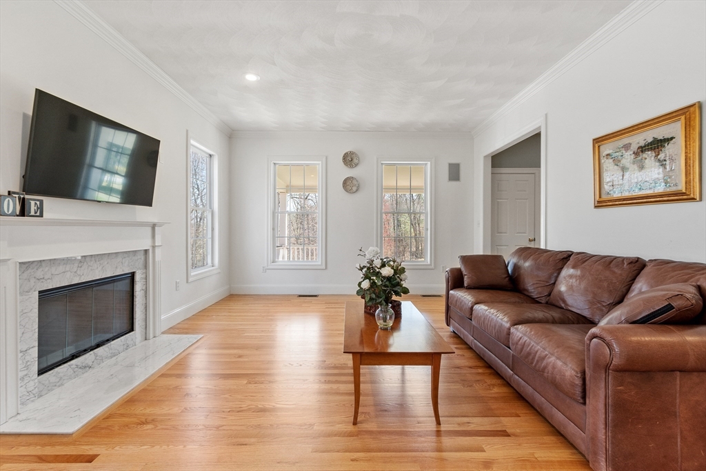 18 Danforth Lane Bolton, MA 01740 - Photo 12 of 29 a living room with furniture a flat screen tv and a fireplace