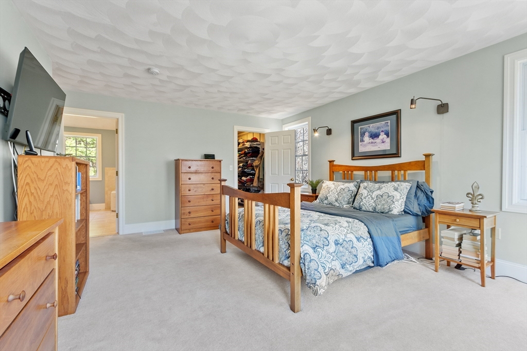 18 Danforth Lane Bolton, MA 01740 - Photo 17 of 29 a bedroom with furniture and a flat screen tv