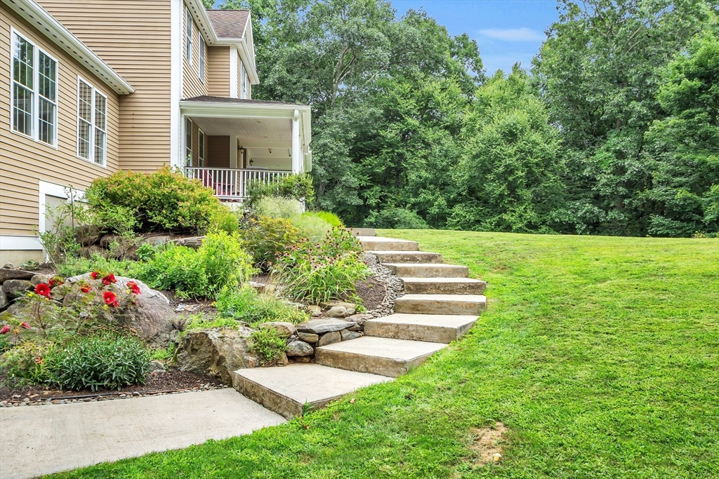 18 Danforth Lane Bolton, MA 01740 - Photo 24 of 29 a view of a house with a garden and pathway