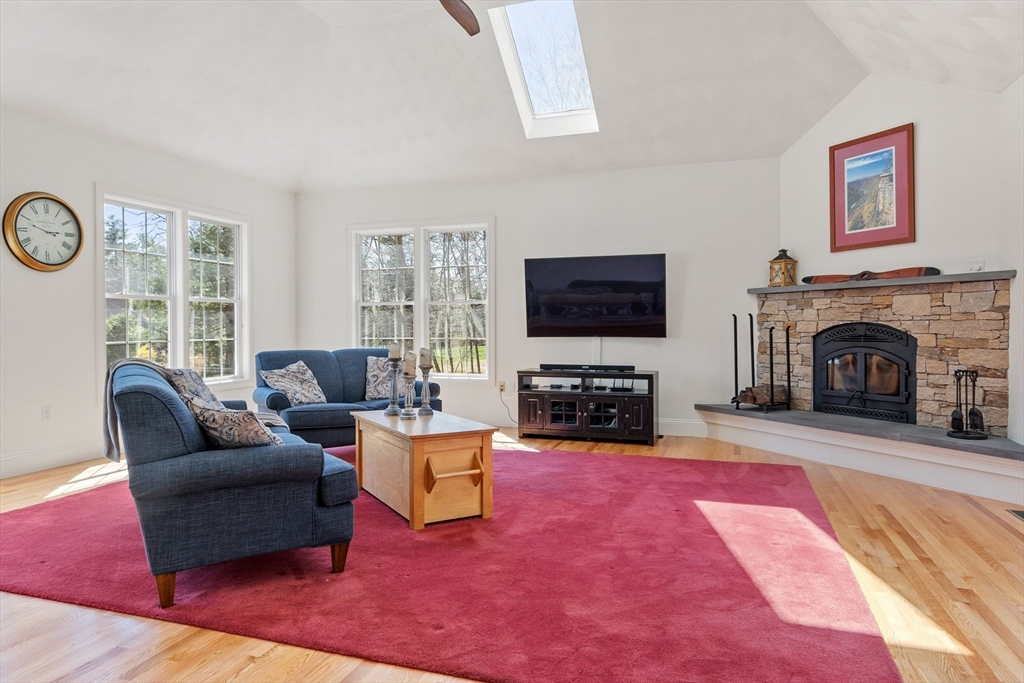 18 Danforth Lane Bolton, MA 01740 - Photo 7 of 29 a living room with furniture a fireplace and a flat screen tv