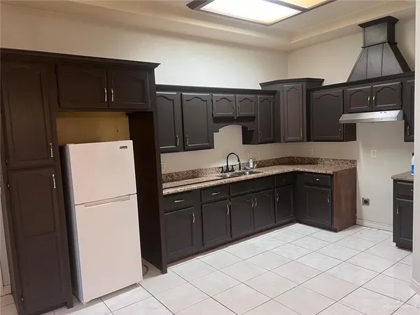 a kitchen with a refrigerator and a sink