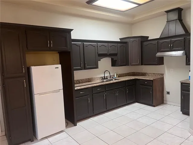 a kitchen with a refrigerator and a sink