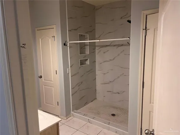 a bathroom with a glass shower door