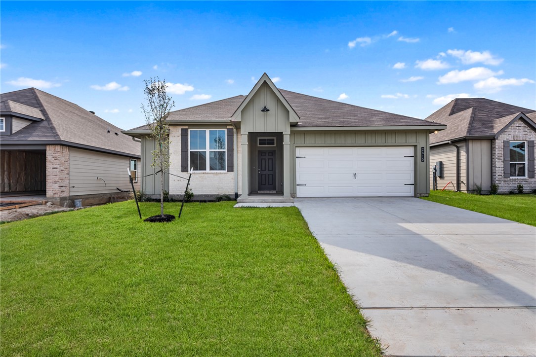 2415 Rooke Road Bryan, TX 77807 - Photo 2 of 36 a front view of a house with a yard and garage