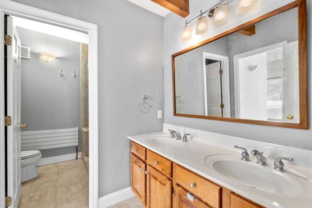 56 Millbrook Road Medfield, MA 02052 - Photo 16 of 28 a bathroom with a double vanity sink and a mirror