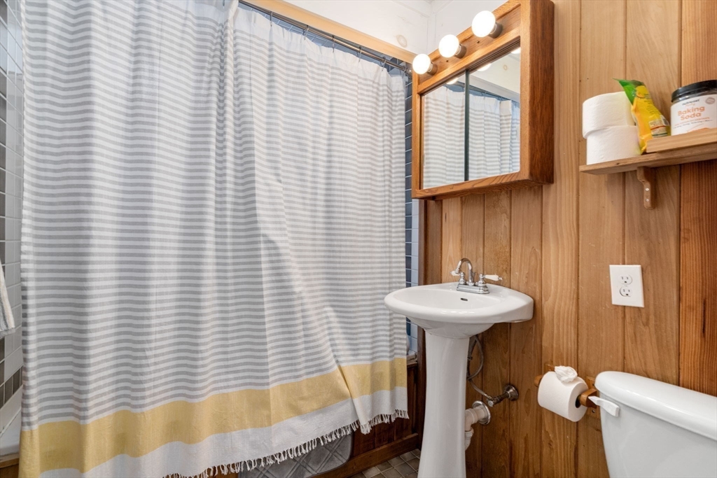 56 Millbrook Road Medfield, MA 02052 - Photo 20 of 28 a bathroom with a sink a mirror and a bathtub