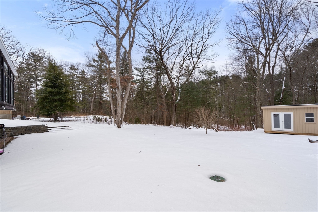 56 Millbrook Road Medfield, MA 02052 - Photo 23 of 28 a street view covered with snow