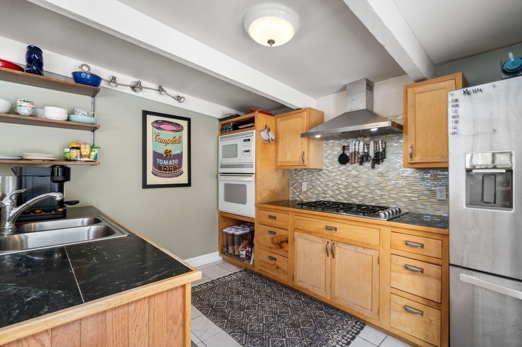 56 Millbrook Road Medfield, MA 02052 - Photo 9 of 28 a kitchen with granite countertop a sink stove and cabinets