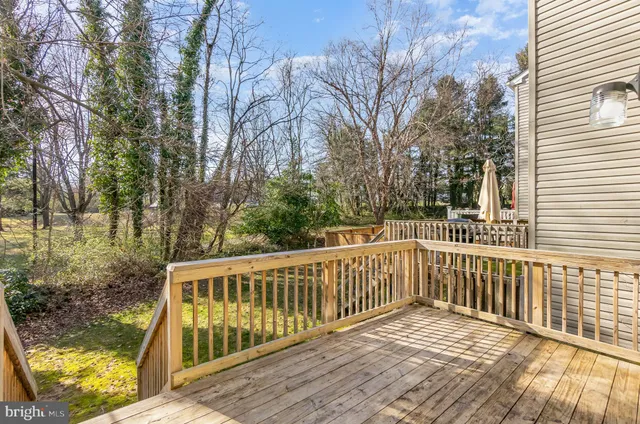 a view of balcony with wooden floor and fence