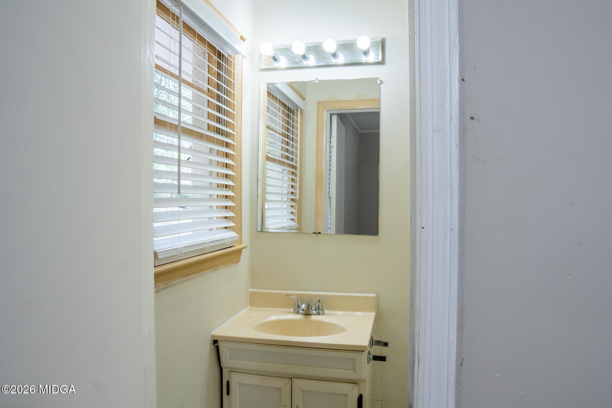 3319 Mohawk Road Macon, GA 31217 - Photo 30 of 38 a bathroom with a sink a mirror and a vanity