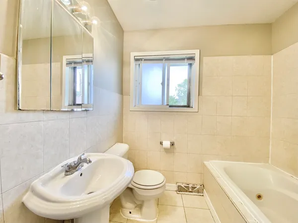 a bathroom with a sink a toilet and bathtub