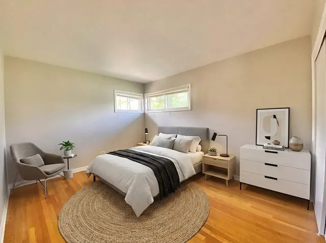 a bed room with a bed and a chair