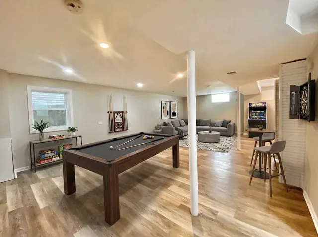 a living room with furniture a table and kitchen view