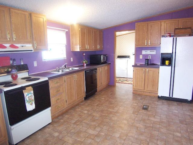 3234 Quarles Road Thaxton, VA 24174 - Photo 4 of 16 a kitchen with a sink stove and refrigerator