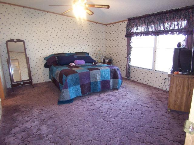 3234 Quarles Road Thaxton, VA 24174 - Photo 8 of 16 a bed sitting in a room next to a window