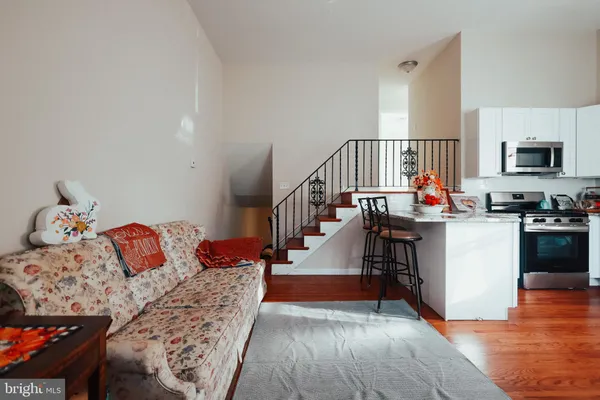 a bedroom with furniture and a wooden floor
