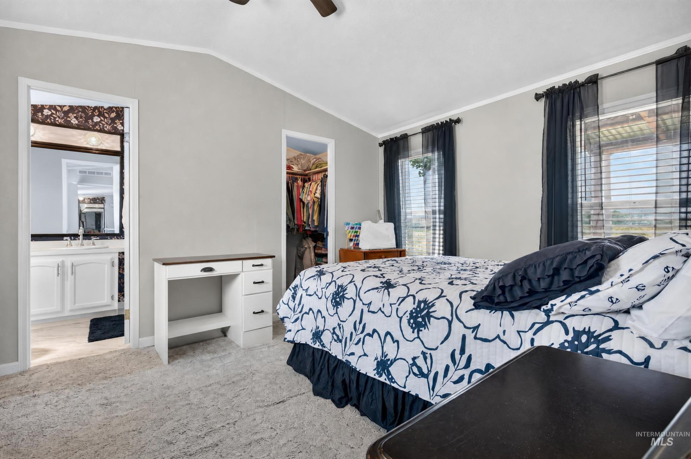 7417 Map Rock Road Caldwell, ID 83607 - Photo 25 of 32 Vaulted ceiling, two windows with blinds, light gray wall color, carpet flooring, and a ceiling fan