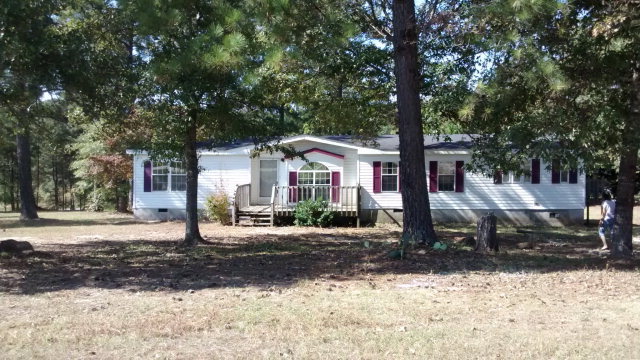 106 Lovett's Ridge Jackson, GA 30233 - Photo 1 of 4 a front view of a house with a yard covered with snow