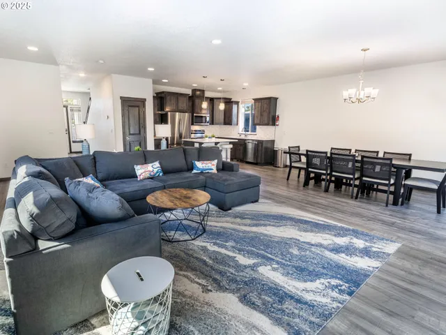 a living room with lots of furniture and kitchen view