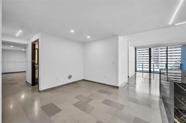 a view of empty room with floor to ceiling window