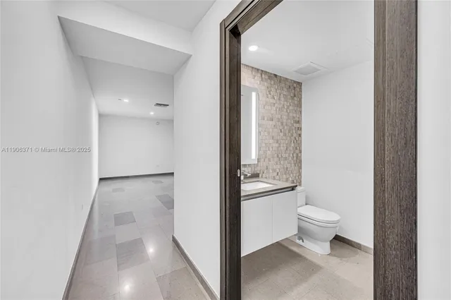 a spacious bedroom with a large bed and a large window