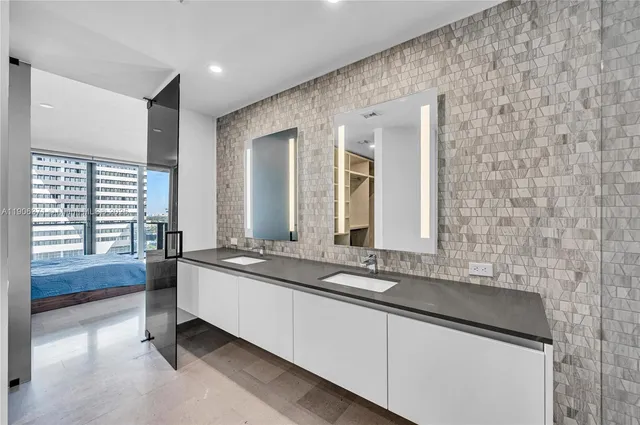 a spacious bathroom with a bathtub shower sink and mirror