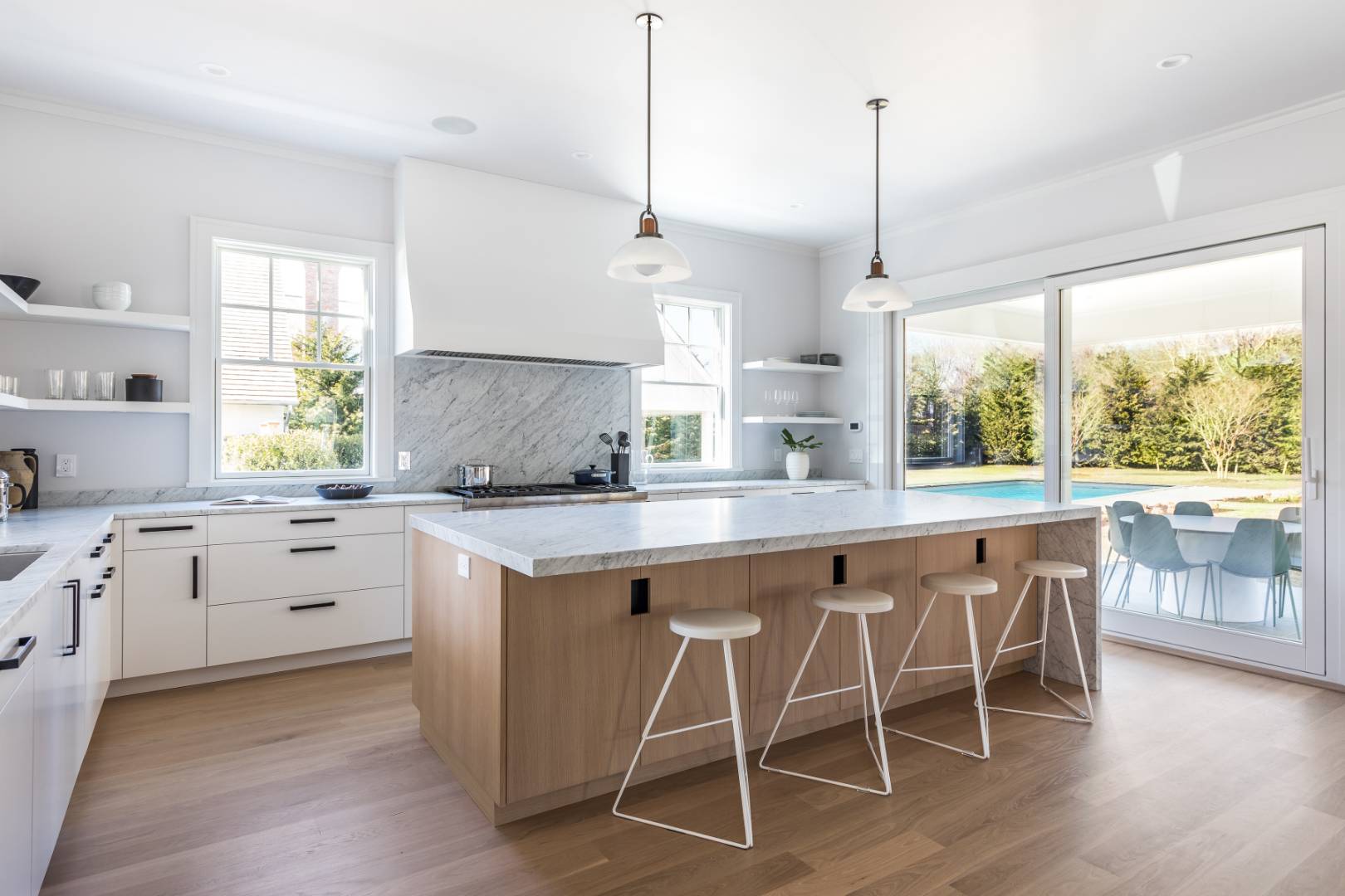 7 Fieldview Lane East Hampton, NY 11937 - Photo 19 of 43 a kitchen with white cabinets and wooden floors