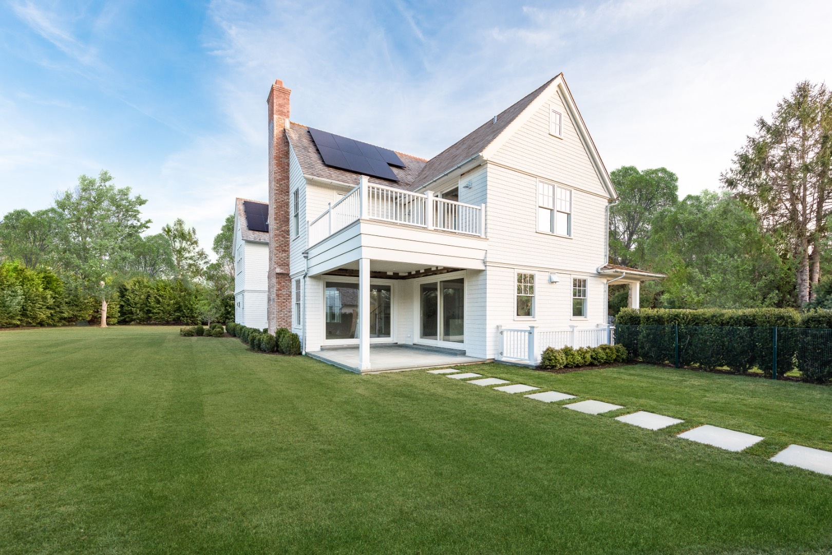 7 Fieldview Lane East Hampton, NY 11937 - Photo 8 of 43 a view of a white house next to a yard with big trees