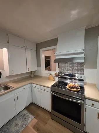 a kitchen with a stove and a sink