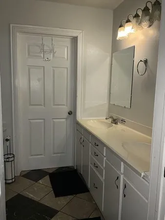 a bathroom with a double vanity sink and mirror